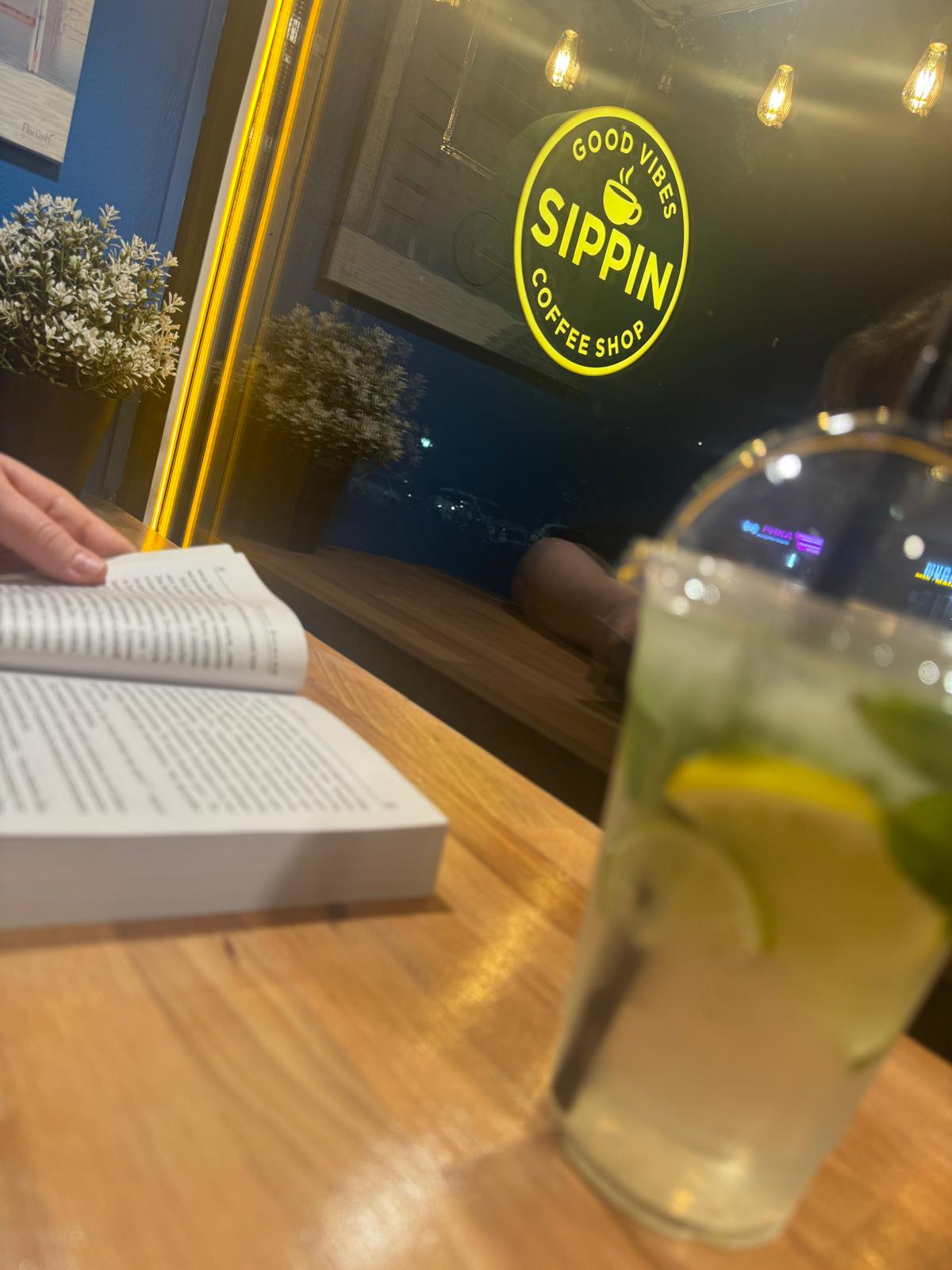 Reading by the window at dusk — Sippin Coffee Almaty